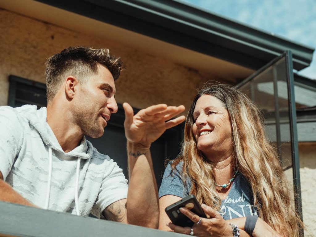 People connecting on an outdoor balcony, signifying connection and community that can be found at Musician Therapy Collective