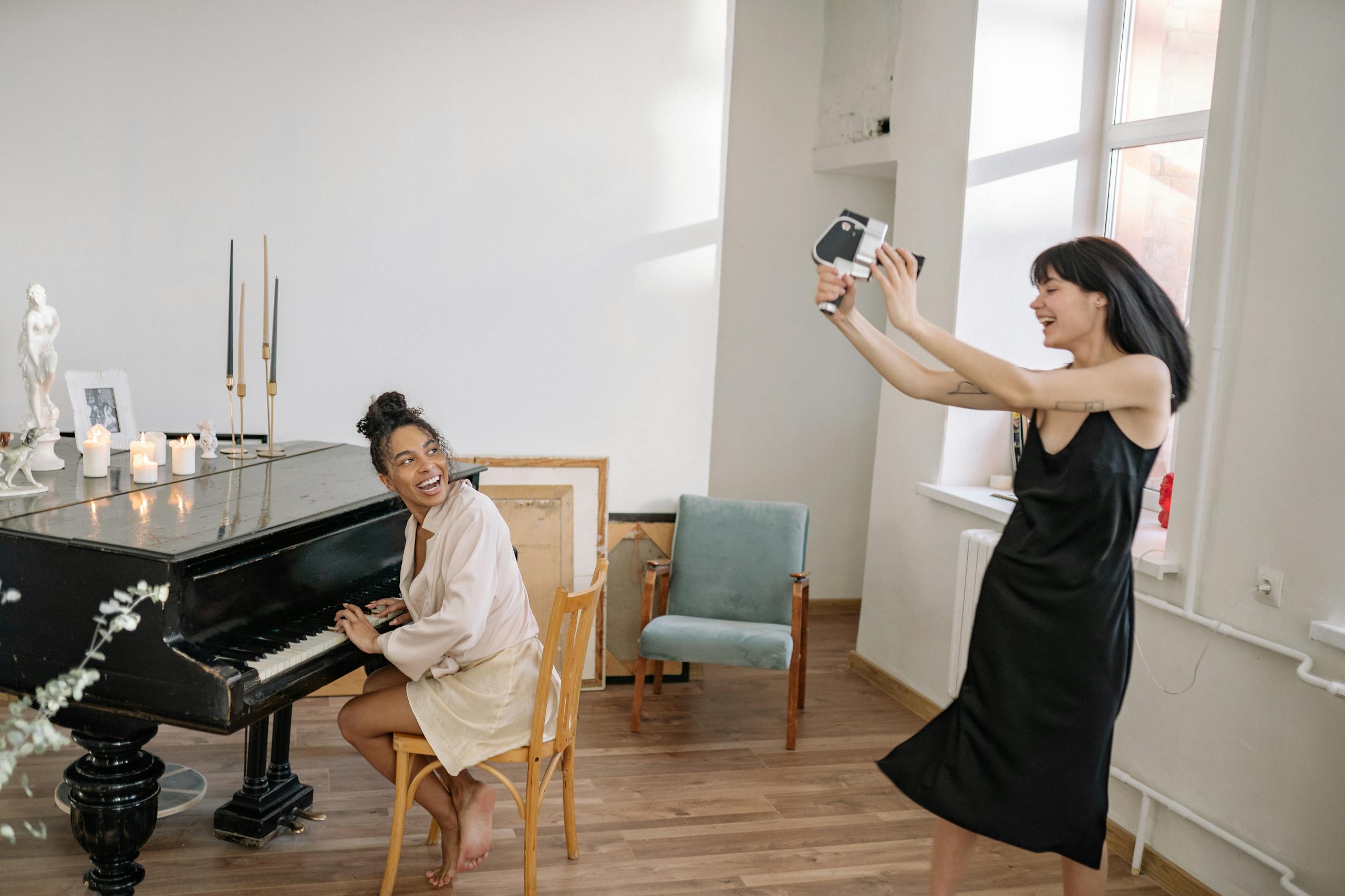 A joyful indoor scene with friends enjoying music and photography.