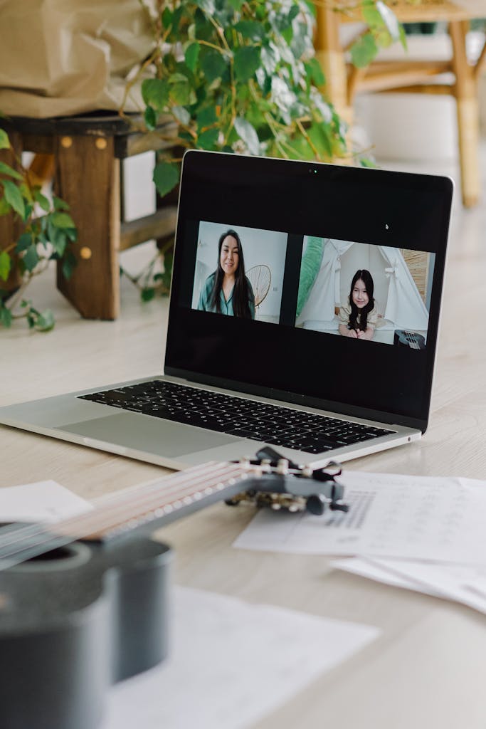 Two women on a video call with a ukulele, connecting through technology.